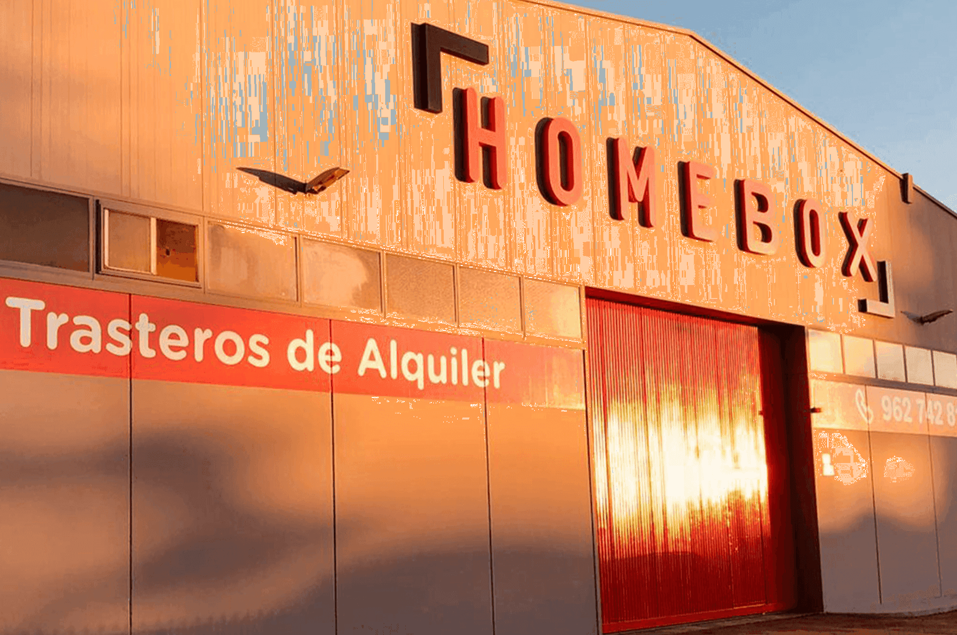 Warehouse facade with HOMEBOX sign at sunset at HOMEBOX Valencia - La Eliana, Avinguda del Paradis, 30 La Eliana Valencia, La Eliana