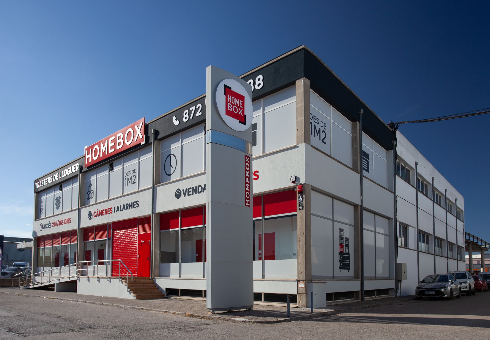 Two-storey HOMEBOX building with illuminated signage and totem pole at HOMEBOX Girona, N-II a, 19, Fornells de la Selva