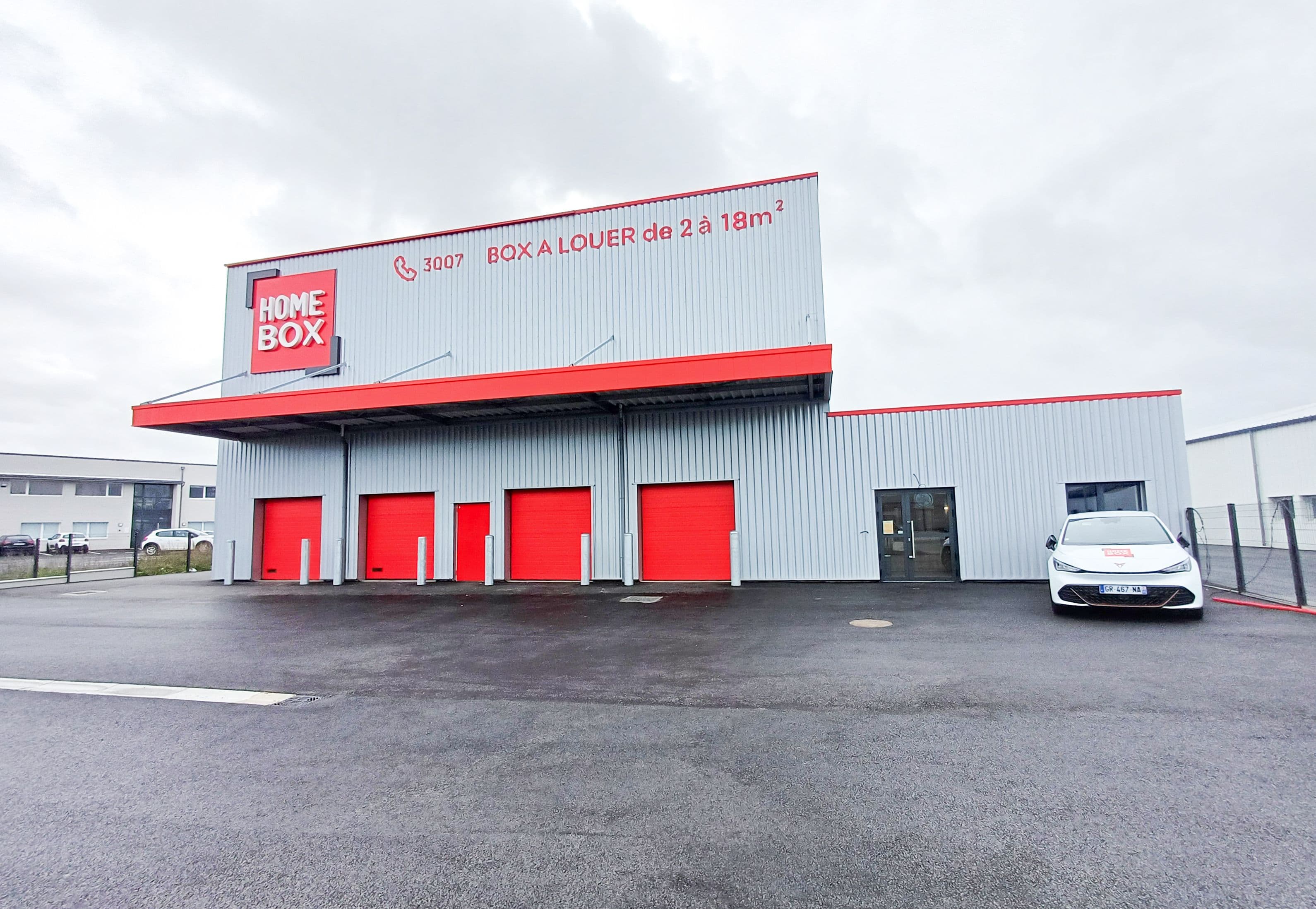 Façade du centre HOMEBOX Cherbourg, 195 rue des Entreprises, avec portes roulantes rouges.