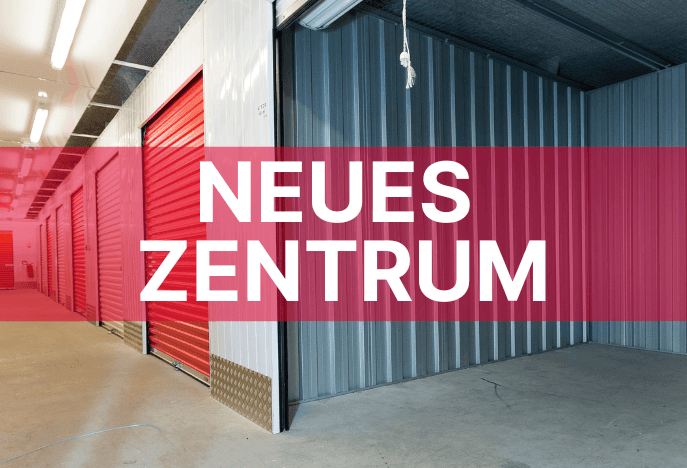 Indoor storage corridor with red and grey roll-up doors at HOMEBOX Stuttgart